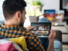 Man Choosing Movie For Streaming On Tablet